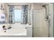 Bright bathroom with a soaking tub, separate glass shower, and nautical-themed decor at 8755 E Portobello Ave, Mesa, AZ 85212