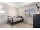 Modest bedroom with carpet flooring, lots of natural light from the window, and neutral paint at 8755 E Portobello Ave, Mesa, AZ 85212