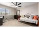 Cozy bedroom featuring a ceiling fan, two-tone walls, and a classic metal bed frame at 8755 E Portobello Ave, Mesa, AZ 85212