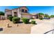 Lovely two-story home featuring a spacious driveway, two-car garage and manicured bushes at 8755 E Portobello Ave, Mesa, AZ 85212