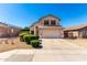 Charming two-story home with a well-kept yard, two-car garage and manicured bushes at 8755 E Portobello Ave, Mesa, AZ 85212