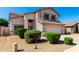 Attractive two-story home boasting a spacious driveway, two-car garage and manicured bushes at 8755 E Portobello Ave, Mesa, AZ 85212