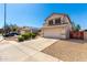 Wonderful two-story home with a two-car garage, gravel landscaping, solar panels and manicured bushes at 8755 E Portobello Ave, Mesa, AZ 85212