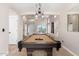 Bright game room with a pool table, abundant natural light, high ceilings and neutral walls at 8755 E Portobello Ave, Mesa, AZ 85212