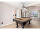 Inviting game room featuring a pool table, high ceilings, modern light fixtures and neutral walls at 8755 E Portobello Ave, Mesa, AZ 85212