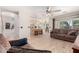 Open-concept living room leading to a modern kitchen with island seating at 8755 E Portobello Ave, Mesa, AZ 85212