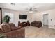 Inviting living room with tile floors, ceiling fan, media center, and comfortable seating at 8755 E Portobello Ave, Mesa, AZ 85212