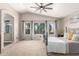 Spacious bedroom featuring large windows, vaulted ceiling, and a luxurious en-suite bathroom at 8755 E Portobello Ave, Mesa, AZ 85212
