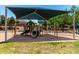 Playground with tube slide and swing-set under large sunshade canopy at 8755 E Portobello Ave, Mesa, AZ 85212