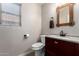Charming powder room with a rustic mirror and updated fixtures at 8755 E Portobello Ave, Mesa, AZ 85212