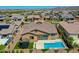 Aerial view of a private backyard featuring a sparkling pool, trampoline, and desert landscape at 9253 W Sands Dr, Peoria, AZ 85383