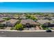 Scenic aerial view of a suburban neighborhood, showcasing a single-story home with lush landscaping at 9253 W Sands Dr, Peoria, AZ 85383
