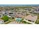 An aerial view of a desert neighborhood showcasing single-Gathering homes, fenced yards, and mountain views at 9253 W Sands Dr, Peoria, AZ 85383