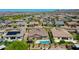 An aerial view of a desert neighborhood featuring single-Gathering homes, pools, and mountain views at 9253 W Sands Dr, Peoria, AZ 85383