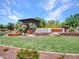 Welcoming entrance to The Meadows community, beautifully landscaped with mature trees at 9253 W Sands Dr, Peoria, AZ 85383
