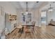 Inviting dining room with wood floors, large window, and a modern chandelier above the wooden table at 9253 W Sands Dr, Peoria, AZ 85383