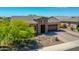 Inviting single-story home with a desert landscape, a stone entryway, and a convenient two-car garage at 9253 W Sands Dr, Peoria, AZ 85383