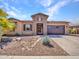 Beautiful single-story home showcasing stone accents, a low-maintenance yard, and a two-car garage at 9253 W Sands Dr, Peoria, AZ 85383