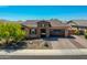 Charming home features stone accents, a tile roof, and a well-manicured front yard at 9253 W Sands Dr, Peoria, AZ 85383