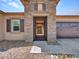 Inviting front entryway with a decorative security gate, stone facade, and a well-manicured pebble yard at 9253 W Sands Dr, Peoria, AZ 85383