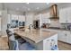 Modern kitchen with a large central island, stainless steel appliances, and stylish white cabinets at 9253 W Sands Dr, Peoria, AZ 85383