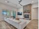 Open living room features a stone fireplace, ceiling fan, and contemporary decor at 9253 W Sands Dr, Peoria, AZ 85383