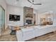 Bright living room with stone fireplace, ceiling fan, and views into dining area at 9253 W Sands Dr, Peoria, AZ 85383