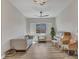 Cozy living room with a decorative ceiling fan, a large window, and a piano, perfect for relaxation at 9253 W Sands Dr, Peoria, AZ 85383