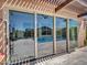 Covered patio with tile flooring and large sliding glass doors leading to pool area at 9253 W Sands Dr, Peoria, AZ 85383