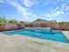 Refreshing pool and patio area features travertine tile surround and a waterfall feature at 9253 W Sands Dr, Peoria, AZ 85383