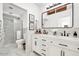 Modern bathroom features a double vanity, black hardware, and updated shower at 9601 N 35Th Dr, Phoenix, AZ 85051