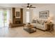 Cozy living room with a brick fireplace, ceiling fan and charming farmhouse decor at 9601 N 35Th Dr, Phoenix, AZ 85051