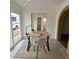 Bright living space with a modern desk, slider door, archway, and closet doors at 9601 N 35Th Dr, Phoenix, AZ 85051