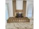 Classic fireplace with brick surround on top of cream and brown marble-look floors at 9601 N 35Th Dr, Phoenix, AZ 85051