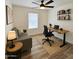Comfortable home office with modern desk, shelving, and cozy seating area at 9601 N 35Th Dr, Phoenix, AZ 85051