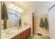Bathroom featuring a double vanity, updated fixtures, and a shower/tub combo at 9713 E El Paso St, Mesa, AZ 85207