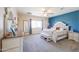 This spacious primary bedroom boasts ample natural light, a accent wall, and a sitting bench at 9713 E El Paso St, Mesa, AZ 85207