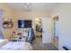 Bedroom features a desk, closet, and large TV at 9713 E El Paso St, Mesa, AZ 85207