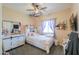 Comfortable bedroom with a ceiling fan and soft natural light coming in from a window at 9713 E El Paso St, Mesa, AZ 85207