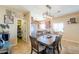 Inviting dining area with a wooden table set, pendant lighting, and decorative wall art at 9713 E El Paso St, Mesa, AZ 85207