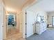 The hallway features a mix of carpeted and tiled flooring, along with neutral-colored walls at 9713 E El Paso St, Mesa, AZ 85207