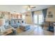 Inviting living room featuring a comfortable sectional sofa, ottoman, and sliding glass doors at 9713 E El Paso St, Mesa, AZ 85207
