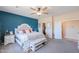 This primary bedroom boasts ample natural light, a accent wall, and a sitting bench at 9713 E El Paso St, Mesa, AZ 85207