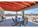 Covered patio area with an outdoor dining set and a concrete floor, perfect for entertaining and enjoying the outdoors at 9713 E El Paso St, Mesa, AZ 85207