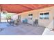 A covered patio area offers a table and seating, perfect for outdoor dining and relaxation, extending the living space at 9713 E El Paso St, Mesa, AZ 85207