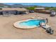 Inviting kidney-shaped swimming pool with a slide and patio area, perfect for outdoor entertaining and relaxation at 9713 E El Paso St, Mesa, AZ 85207