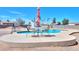 Poolside with an umbrella table, chairs, and ample concrete area, perfect for outdoor dining, lounging, and recreation at 9713 E El Paso St, Mesa, AZ 85207