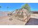 A fenced-in backyard features a small structure, offering secure space for animals or gardening at 9713 E El Paso St, Mesa, AZ 85207