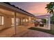 Spacious covered patio with an outdoor kitchen, ample seating around a fire pit, and direct access to the home at 9809 W Behrend Dr, Peoria, AZ 85382