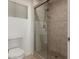 Tiled stand up shower in a bathroom with tile flooring and a toilet at 9809 W Behrend Dr, Peoria, AZ 85382